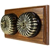 2 Fluted Antique Brass Dome Switches on Horizontal Wooden Pattress
