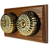 2 Fluted Polished Brass Dome Switches on Horizontal Wooden Pattress