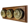 3 Fluted Polished Brass Dome Switches on Horizontal Wooden Pattress