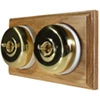 2 Polished Brass Dome Switches on Horizontal Wooden Pattress