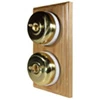 2 Polished Brass Dome Switches on Vertical Wooden Pattress