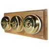 3 Polished Brass Dome Switches on Horizontal Wooden Pattress